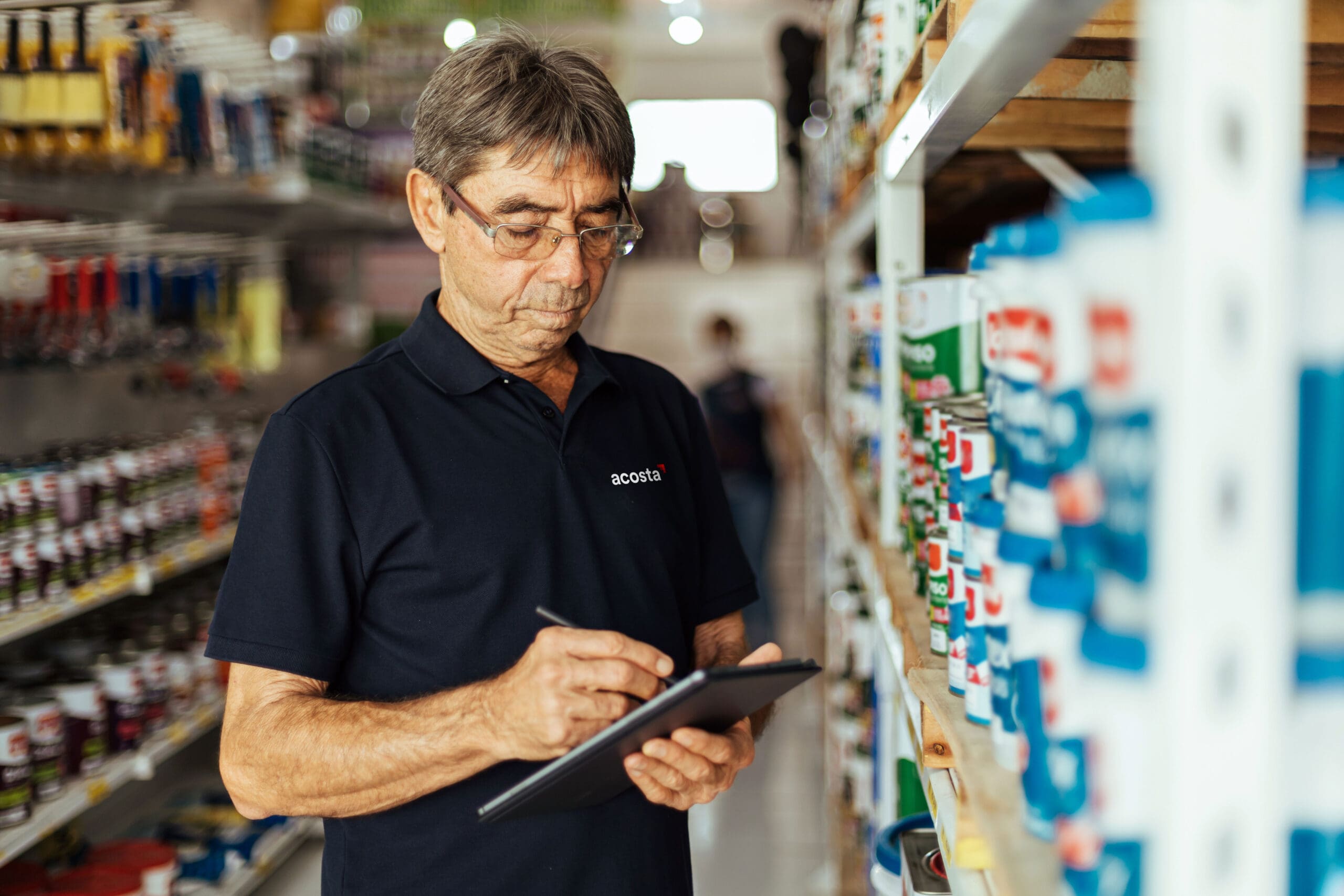 man checking stock in store